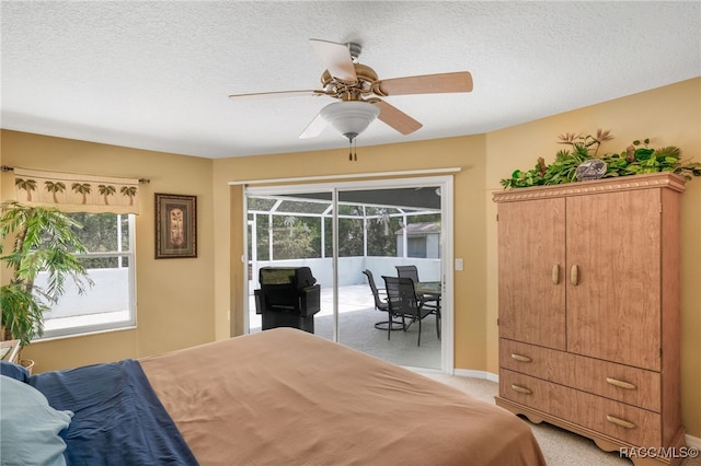2617 E Newhaven St, Inverness, FL 34453 - bedroom featuring access to outside, light colored carpet, multiple windows, baseboards, and a textured ceiling