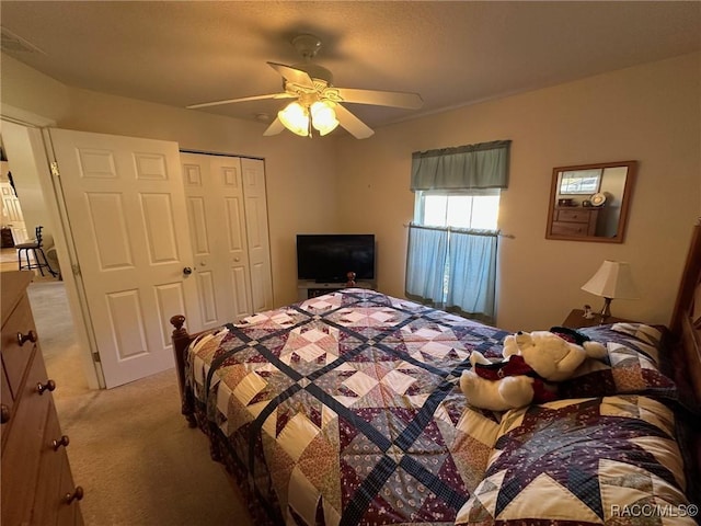 bedroom featuring light carpet, a closet, and ceiling fan