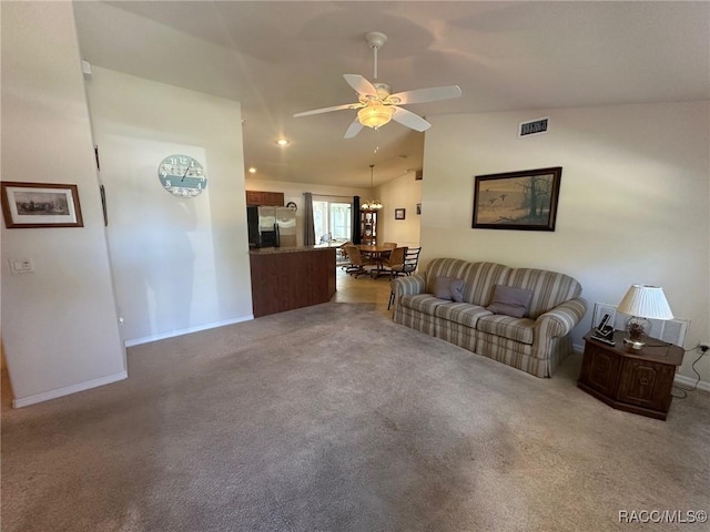 carpeted living area with visible vents, baseboards, vaulted ceiling, and ceiling fan