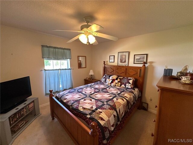 bedroom with baseboards, a ceiling fan, and carpet flooring