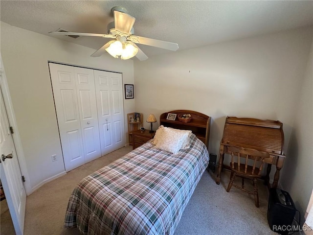 bedroom with a closet, baseboards, a ceiling fan, and light carpet