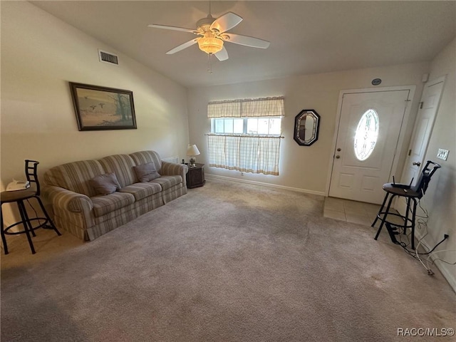 carpeted living room featuring baseboards, vaulted ceiling, a ceiling fan, and visible vents
