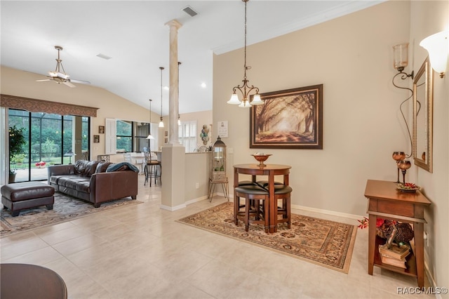 dining space with light tile patterned floors, ceiling fan with notable chandelier, and lofted ceiling