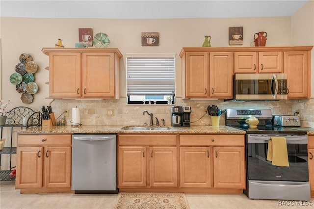 kitchen with light tile patterned flooring, appliances with stainless steel finishes, tasteful backsplash, and sink