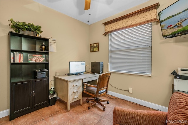 tiled office space featuring ceiling fan