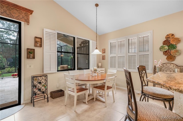 tiled dining area with vaulted ceiling