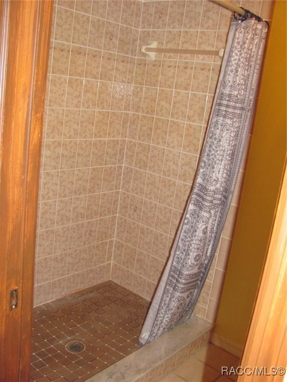 bathroom with a shower with curtain