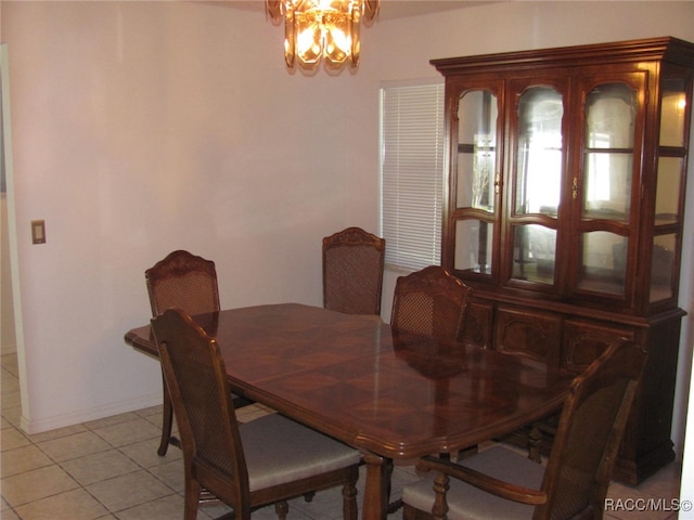 tiled dining room featuring a notable chandelier