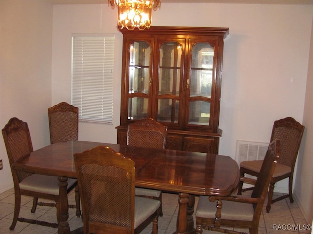 tiled dining area with a notable chandelier