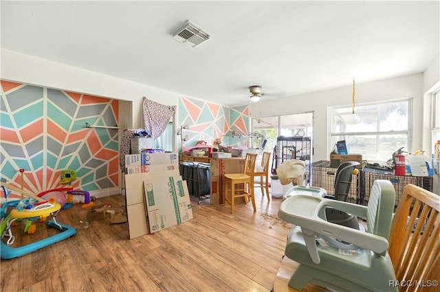 interior space with wood finished floors and ceiling fan
