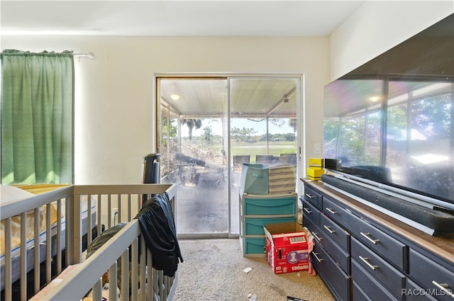 bedroom with carpet flooring, multiple windows, and access to exterior