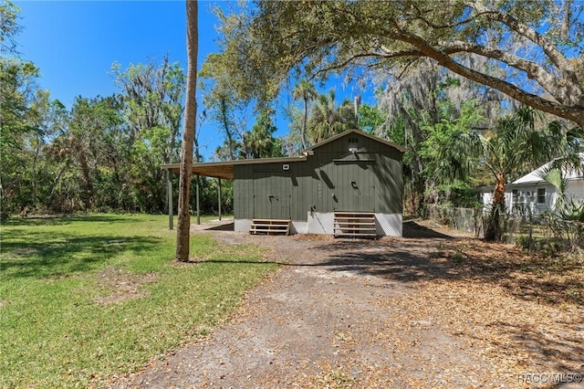 exterior space with a yard, an outdoor structure, and entry steps