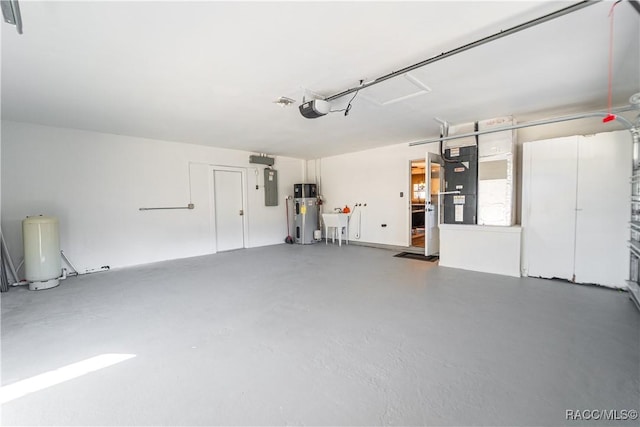 garage with heating unit, electric panel, a garage door opener, and water heater