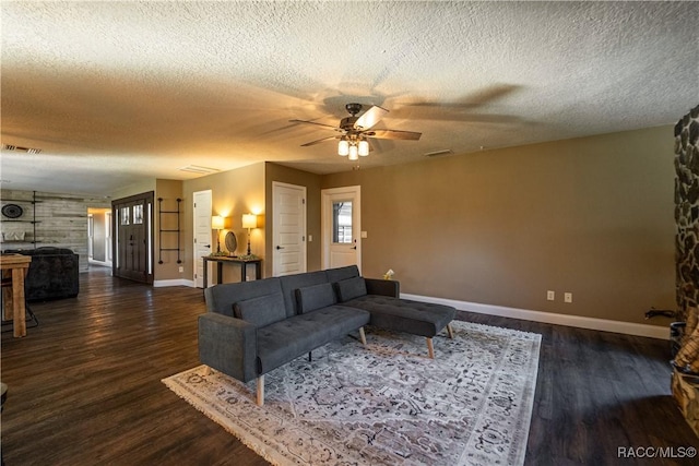 living room featuring a textured ceiling, dark hardwood / wood-style floors, and ceiling fan