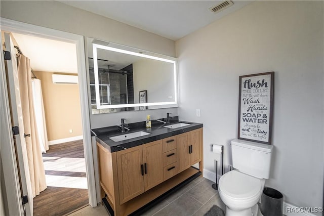 bathroom with vanity, a wall mounted AC, wood-type flooring, toilet, and curtained shower