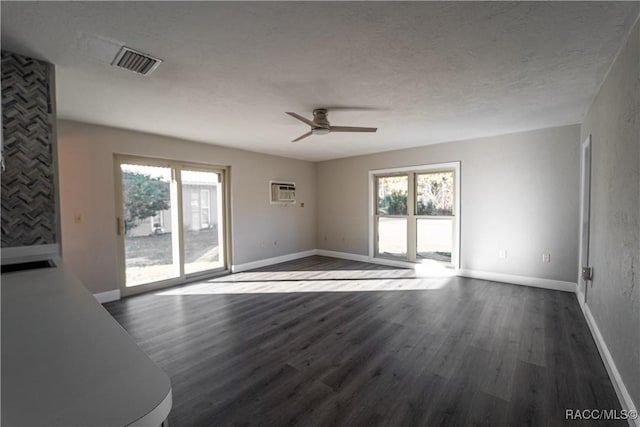 unfurnished living room with a textured ceiling, dark hardwood / wood-style floors, and ceiling fan