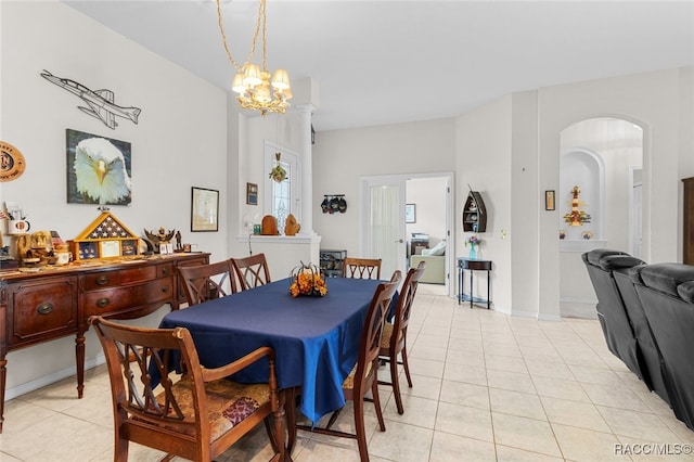 tiled dining room featuring a notable chandelier