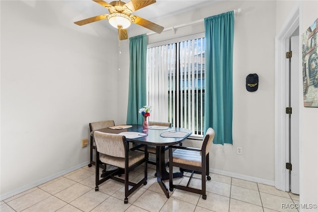 dining room with light tile patterned floors and ceiling fan