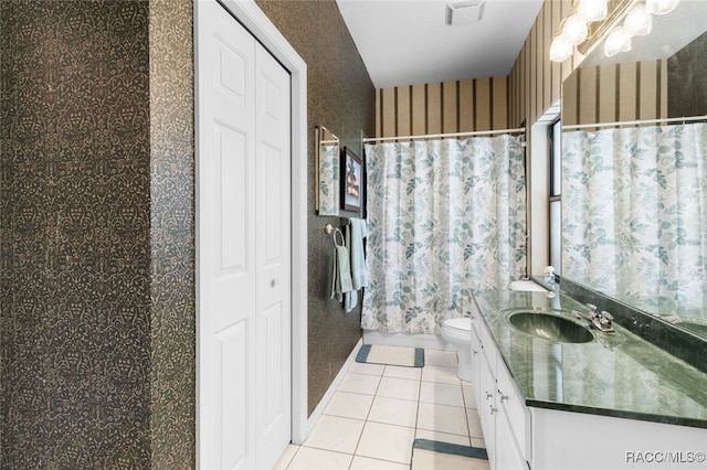 bathroom featuring tile patterned floors, curtained shower, vanity, and toilet