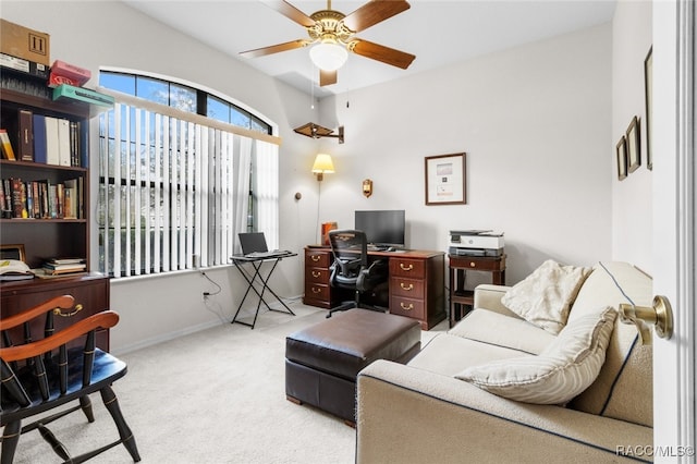 carpeted office space featuring ceiling fan