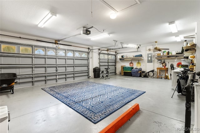 garage with electric panel and a garage door opener