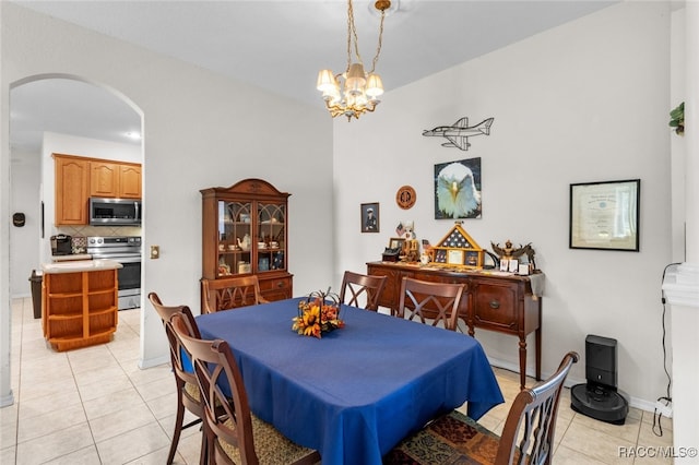 dining room featuring light tile patterned flooring and a chandelier