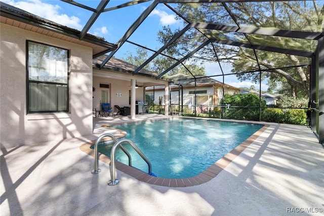 view of swimming pool featuring a lanai and a patio