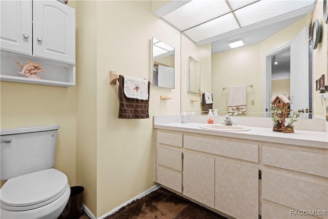 bathroom featuring vanity and toilet