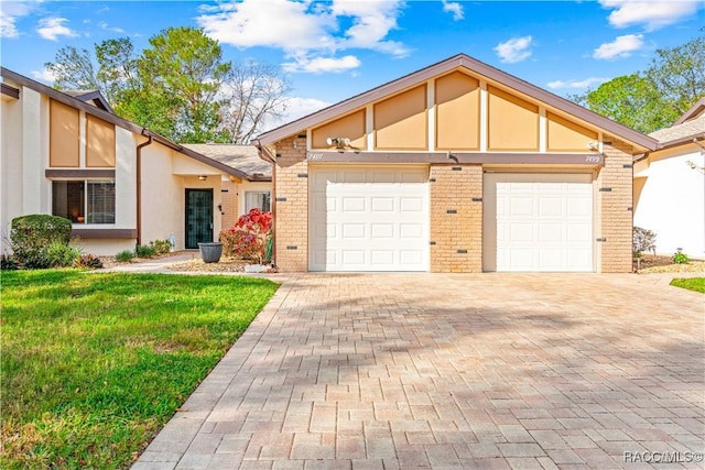 english style home with a garage and a front lawn