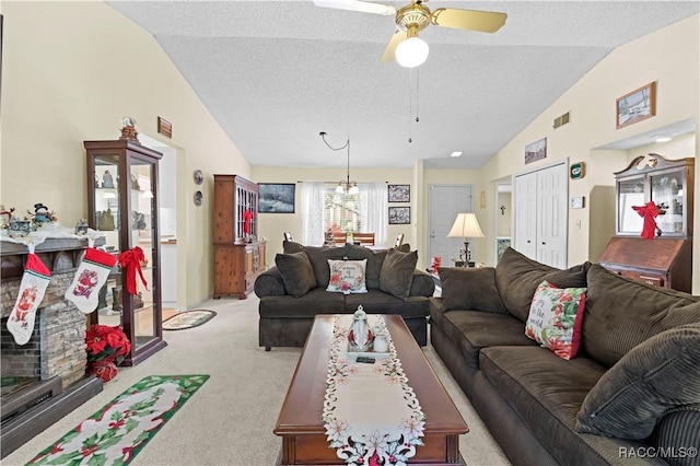 carpeted living room with lofted ceiling, ceiling fan with notable chandelier, and a textured ceiling