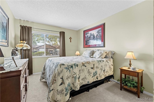 bedroom featuring light colored carpet and a textured ceiling