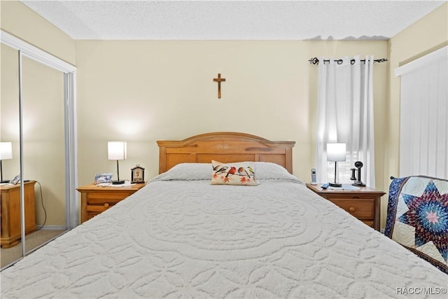 bedroom featuring carpet floors and a textured ceiling