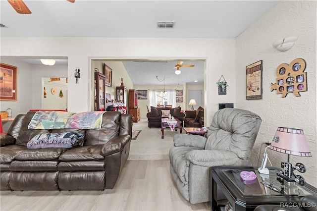 living room with light hardwood / wood-style floors and ceiling fan