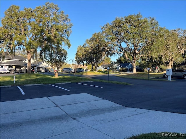 view of parking featuring a lawn