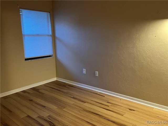 unfurnished room with hardwood / wood-style floors