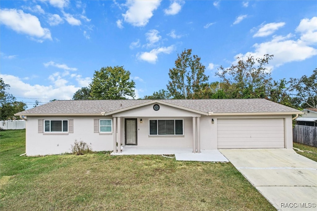 ranch-style house with a garage and a front yard