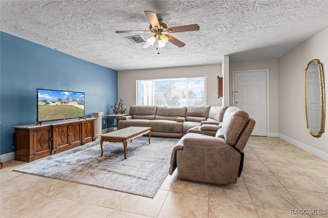 tiled living room featuring ceiling fan and a textured ceiling