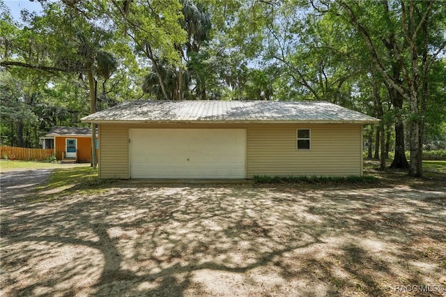 detached garage featuring fence