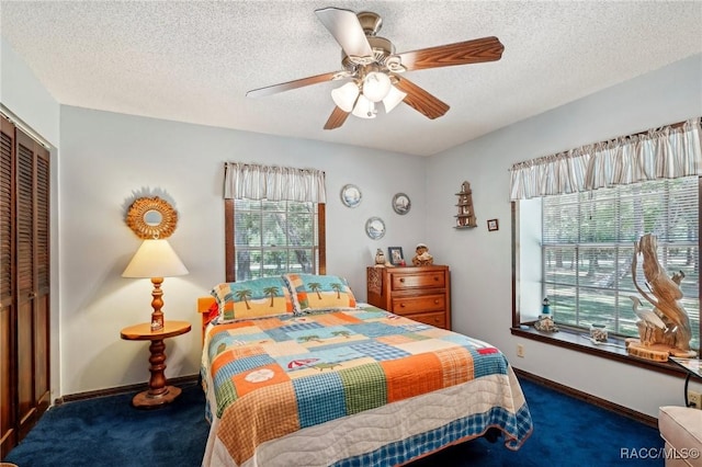 bedroom featuring carpet floors, a textured ceiling, ceiling fan, and a closet