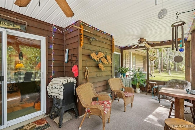 sunroom / solarium with a ceiling fan
