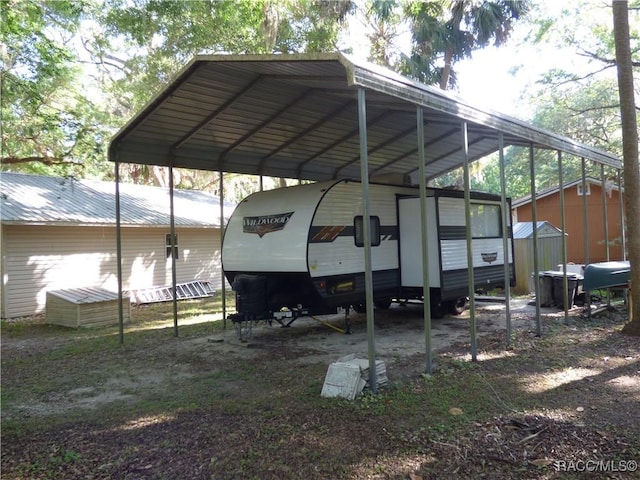 view of car parking featuring a carport and a shed