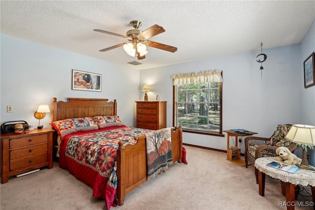bedroom featuring carpet flooring, ceiling fan, a textured ceiling, baseboards, and visible vents