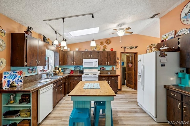 kitchen featuring ceiling fan, a sink, white appliances, a textured ceiling, and wooden counters