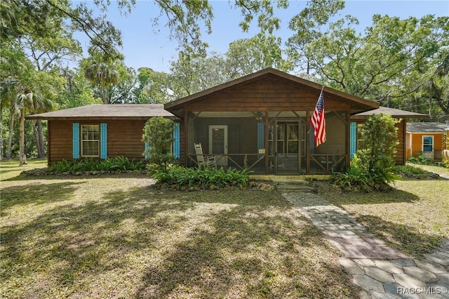ranch-style home with a porch and a front yard