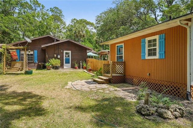 back of property with a lawn