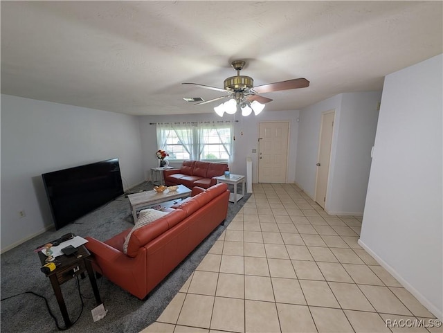 living room featuring a ceiling fan, light tile patterned floors, and baseboards