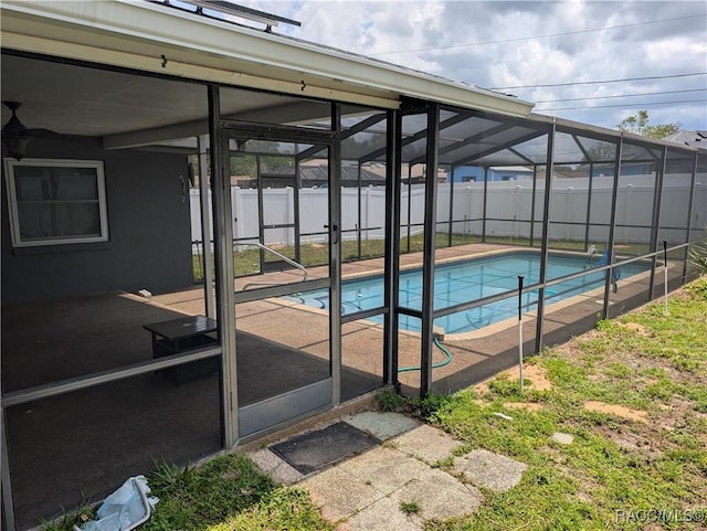 view of pool featuring a fenced backyard, a lanai, and a patio