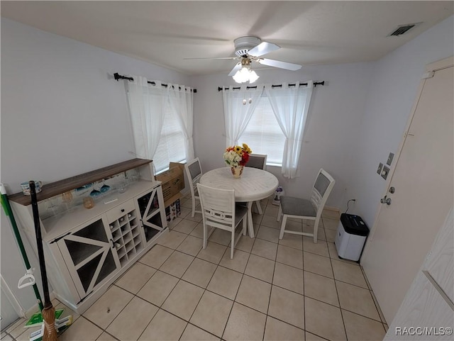 dining space featuring a ceiling fan and light tile patterned floors