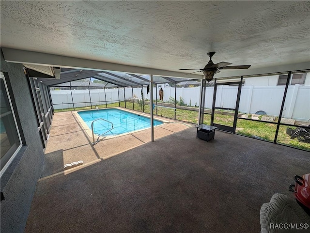 view of pool featuring a lanai, a fenced backyard, a patio, and a ceiling fan