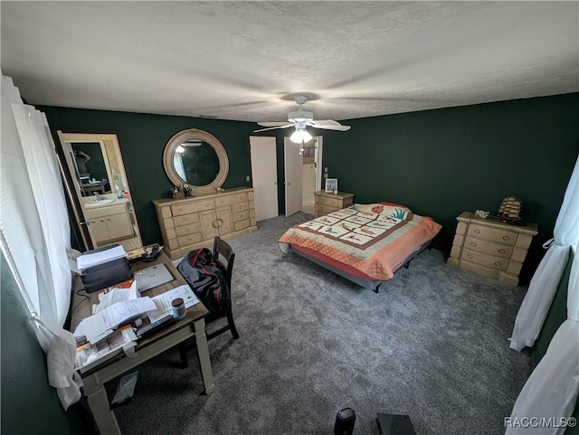 bedroom featuring carpet, ceiling fan, and a sink